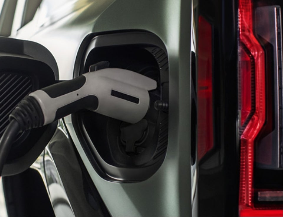 Close up of charging port with charger plugged in on a GMC Hummer EV SUV - Cutter GMC in Waipahu HI